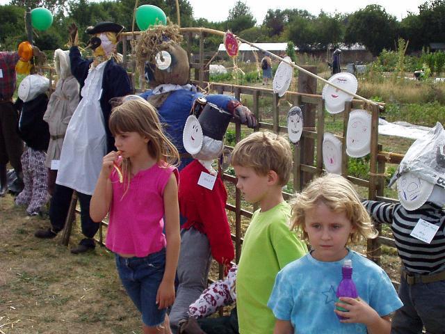 Children admiring scarecrows