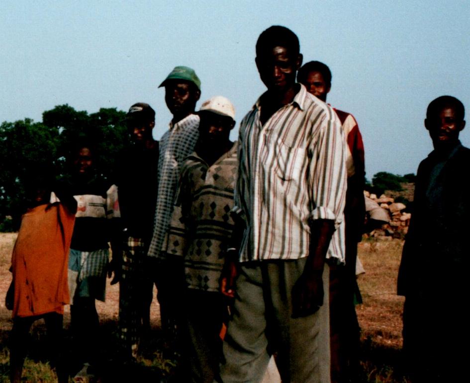 People at Wedie. Baisso Djiguiba, son of village chief, in centre with white cap.