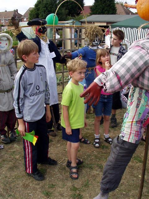 Children admiring scarecrows