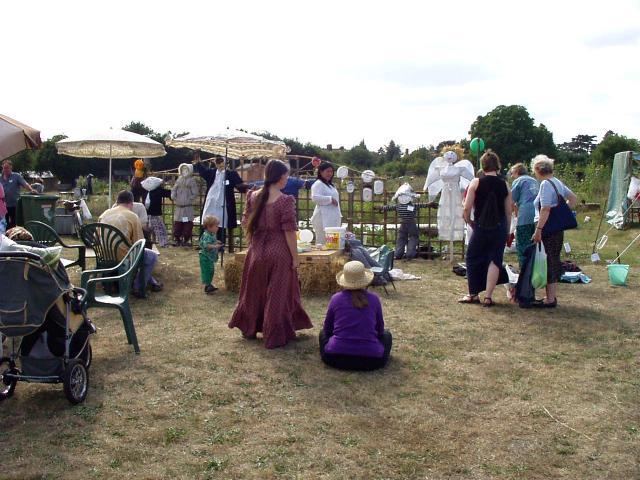Visitors admiring scarecrows